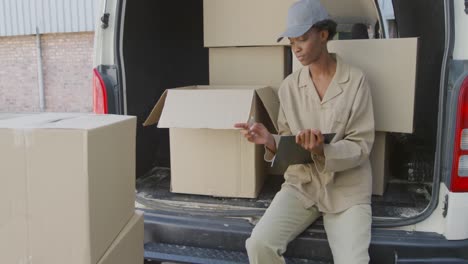 Young-female-van-driver-with-a-warehouse-delivery