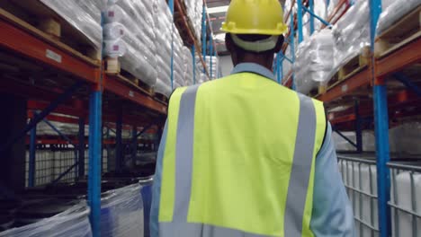 Male-worker-walking-in-a-warehouse