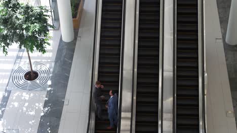 Businessmen-on-an-escalator-in-a-modern-building
