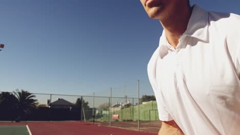 Man-playing-tennis-on-a-sunny-day