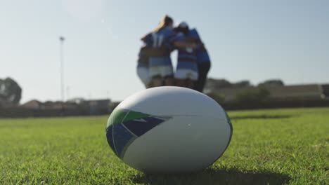 Rugby-ball-and-female-rugby-players-on-a-rugby-pitch