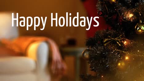 Happy-Holidays-written-in-front-of-defocused-Christmas-tree