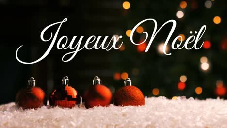 Joyeux-NoÃ«l-written-over-Christmas-baubles