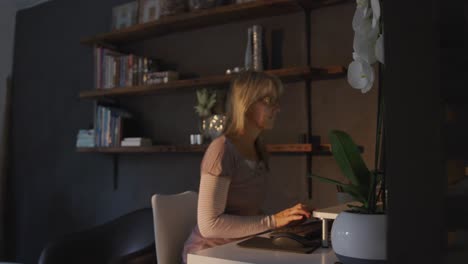 Woman-using-computer-at-home-at-night