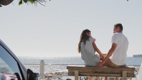 Young-adult-couple-relaxing-by-the-sea