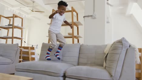 Young-boy-bouncing-on-couch