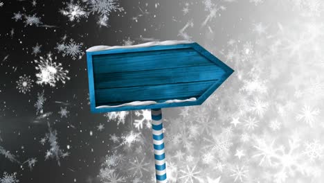 Snow-falling-and-wooden-sign-board