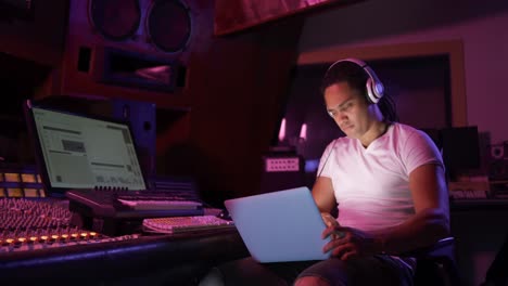 Male-sound-engineer-using-a-laptop