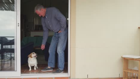 Senior-man-with-his-dog-at-home