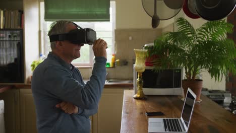 Senior-man-in-VR-headset-at-home
