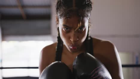 Mixed-race-woman-using-boxing-gloves