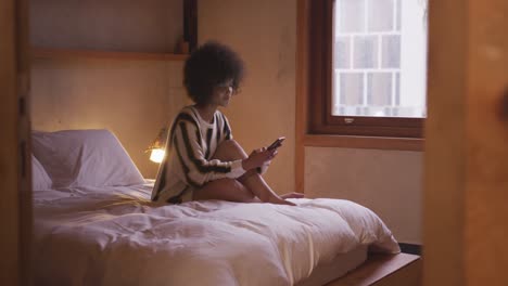 Mixed-race-woman-texting-at-home