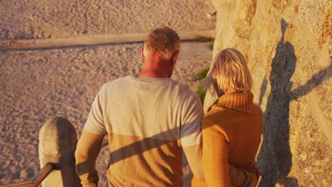 Senior-couple-walking-alongside-beach