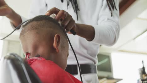 African-man-cutting-African-boy-hair-