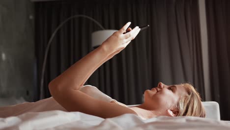 Caucasian-woman-using-smartphone-in-hotel