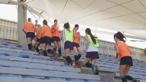Female-hockey-players-warming-up-in-stands