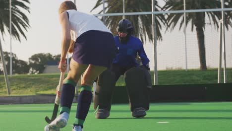 Female-hockey-players-playing-on-the-field