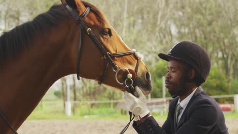 African-American-man-looking-at-his-Dressage-horse