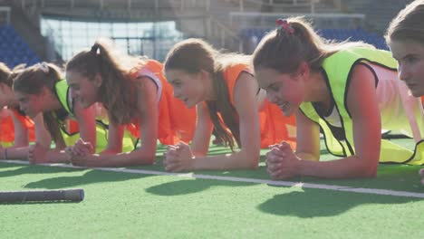 Female-hockey-players-warming-up-on-the-field
