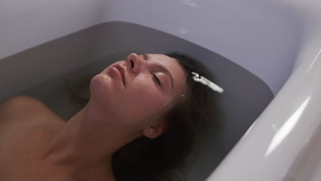 Caucasian-woman-taking-bath-in-hotel