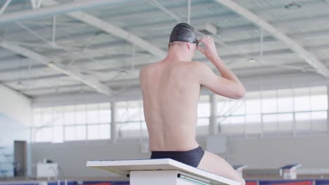 Swimmer-taking-off-his-pool-goggles-