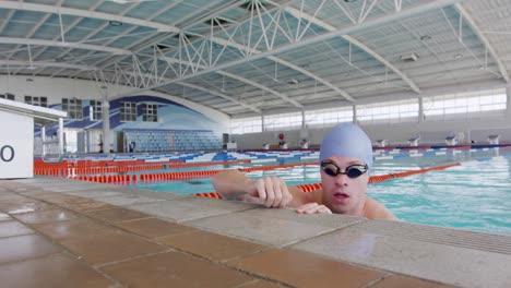 Schwimmer-Kommt-Aus-Dem-Wasser-Und-Blickt-In-Die-Kamera