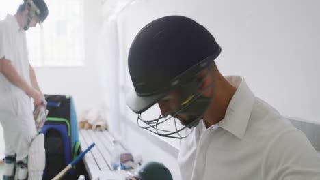 Cricket-playing-putting-on-his-helmet-before-playing