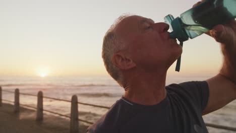 Senior-man-drinking-water-on-the-promenade