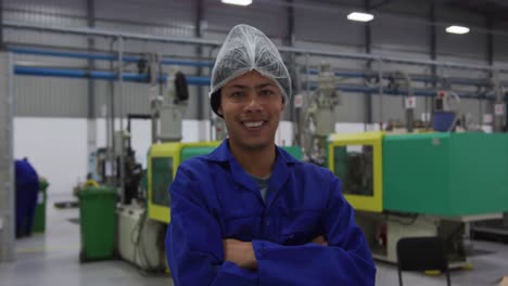 Warehouse-worker-smiling-and-looking-at-camera