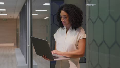 Businesswoman-working-on-laptop-in-a-modern-office