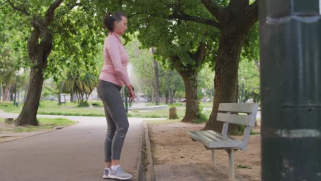 Senior-woman-stretching-her-legs-in-the-park