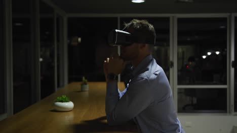 Businessman-using-VR-helmet-in-a-modern-office