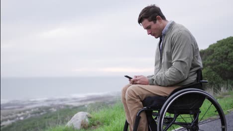 Man-in-a-wheelchair-looking-at-his-phone