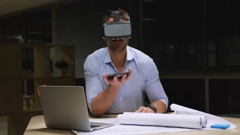 Businessman-using-VR-helmet-in-a-modern-office