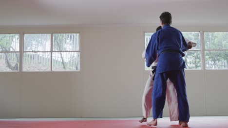 Judokas-training-by-doing-a-randori-on-the-judo-mat