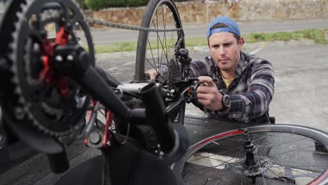 Disabled-man-assembling-parts-of-a-bicycle