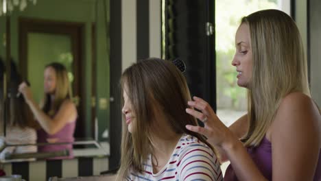 Mother-brushing-the-hair-on-her-daughter