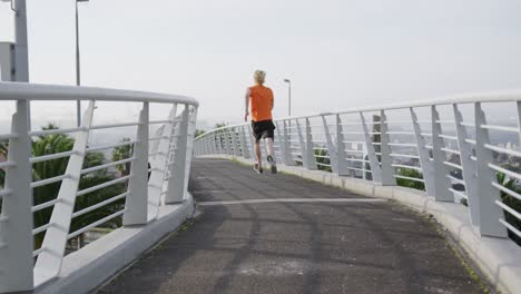 Sporty-Caucasian-man-training-on-a-bridge