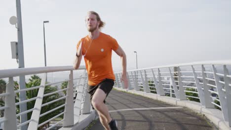 Sporty-Caucasian-man-training-on-a-bridge