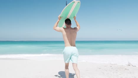 Man-holding-a-surfboard-on-his-head