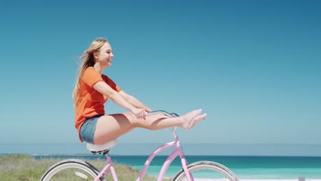 Woman-riding-on-her-bike-on-the-beach-