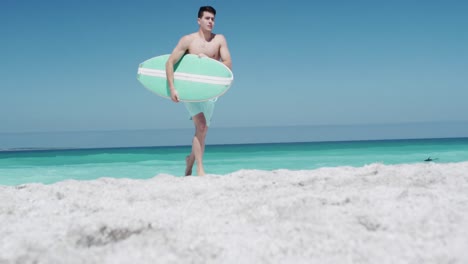 Man-holding-a-surfboard-under-his-arm