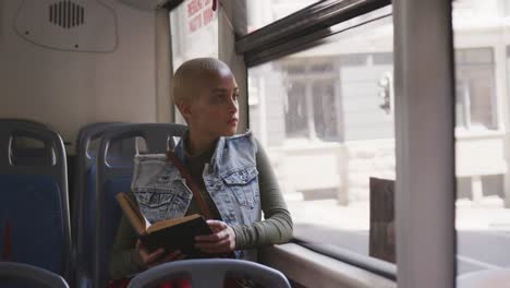 Mujer-De-Raza-Mixta-Tomando-El-Autobús-Y-Leyendo-Un-Libro.