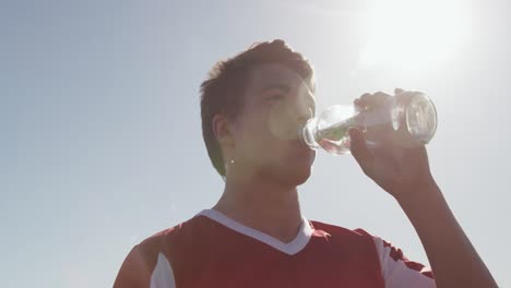 Rugby-player-drinking-water-on-sunny-day