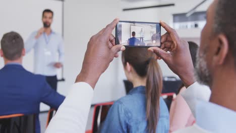 Business-man-taking-videos-of-meeting-in-conference-room