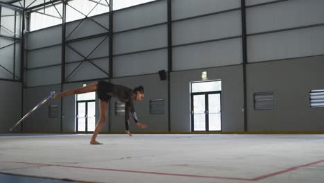 Female-gymnast-performing-at-sports-hall
