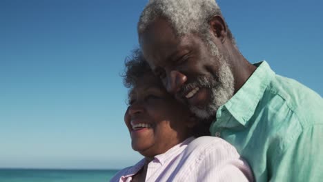 Senior-couple-hugging-at-the-beach