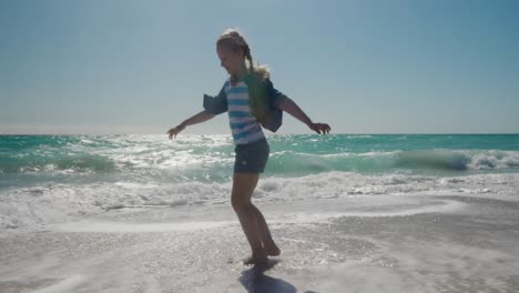 Young-girl-walking-in-the-water-at-the-beach