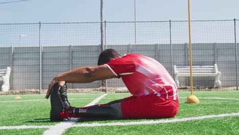 Soccer-player-stretching-on-the-field