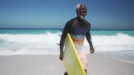 Senior-man-running-with-a-surfboard